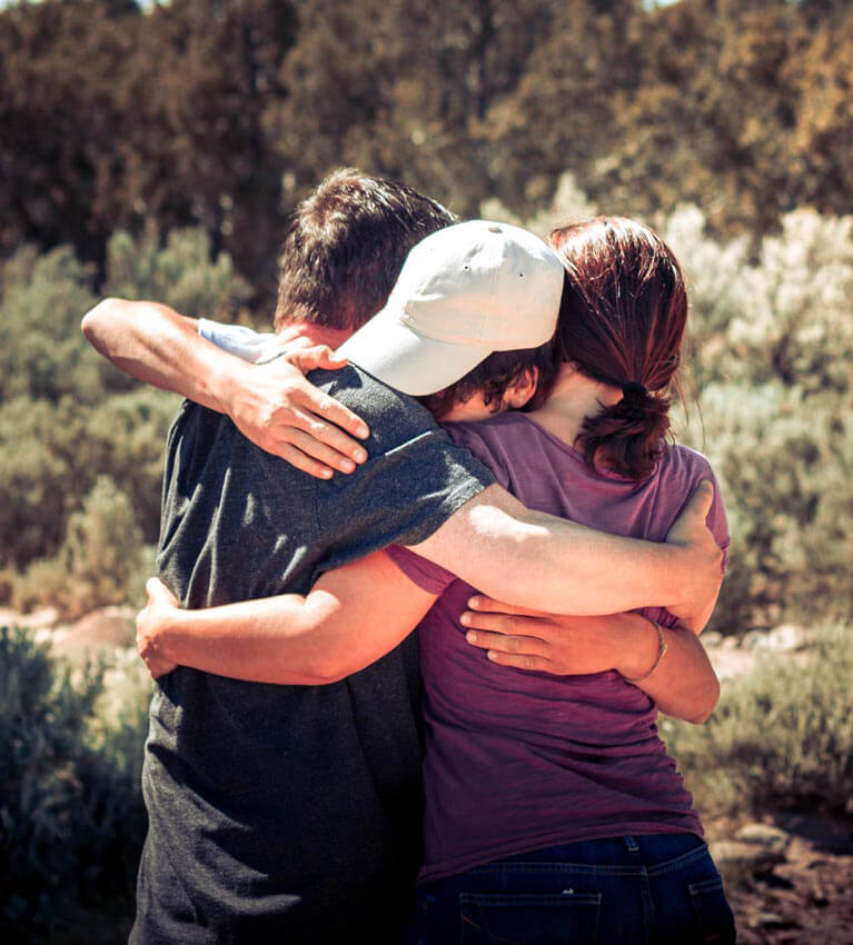 a family hug after success at RedCliff Ascent Wilderness Therapy Program