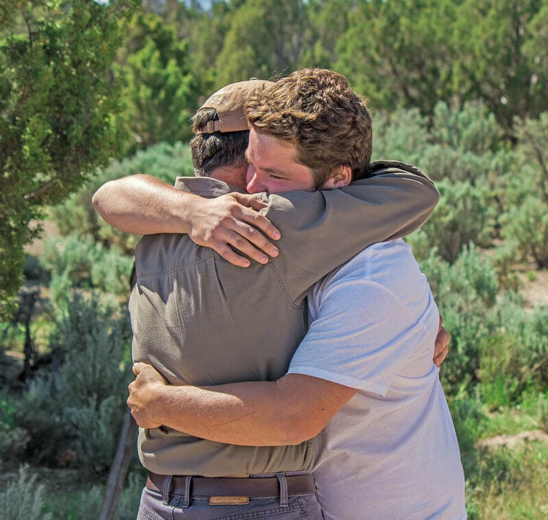 After Wilderness Family Therapy Dad and Kid Hug